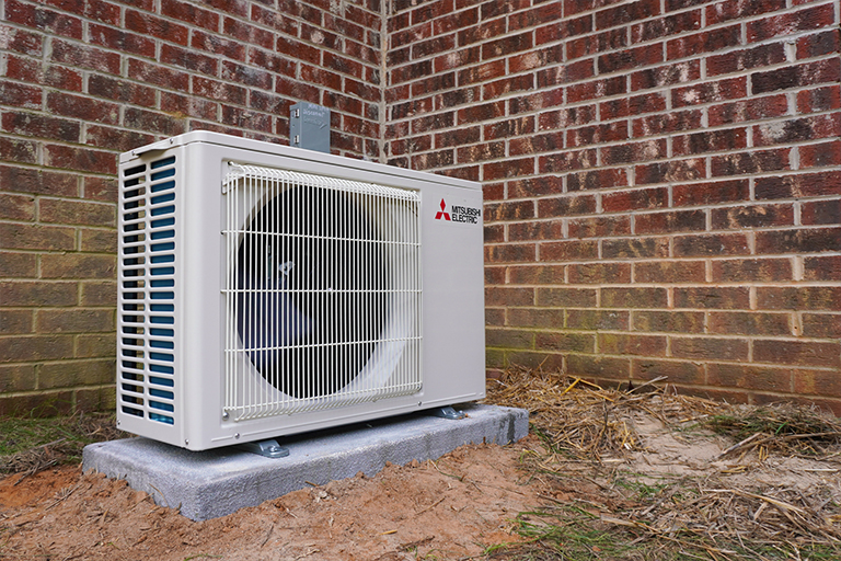 Ductless mini-split outdoor unit outside a home