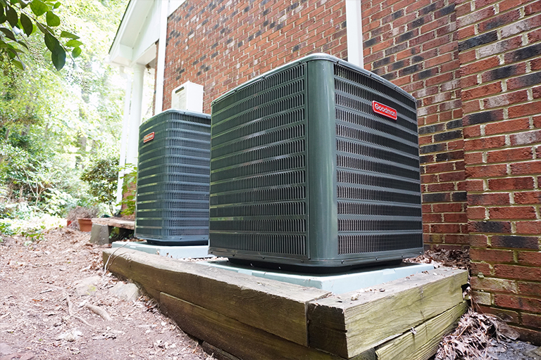 Two new outdoor air conditioners outside of home