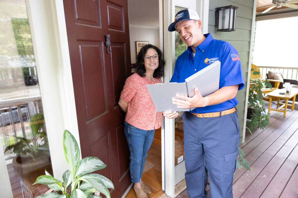 hvac tech discussing heating estimate with homeowner