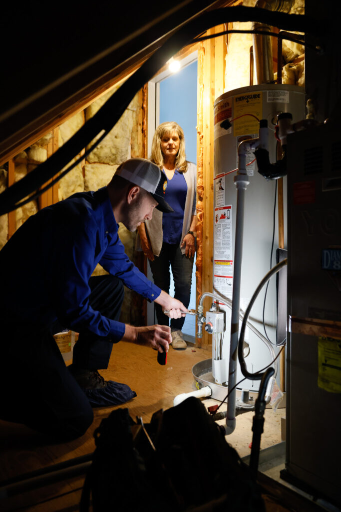 tech working on a water heater