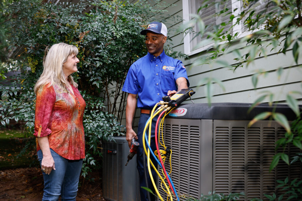 hvac tech discussing ac unit with homeowner