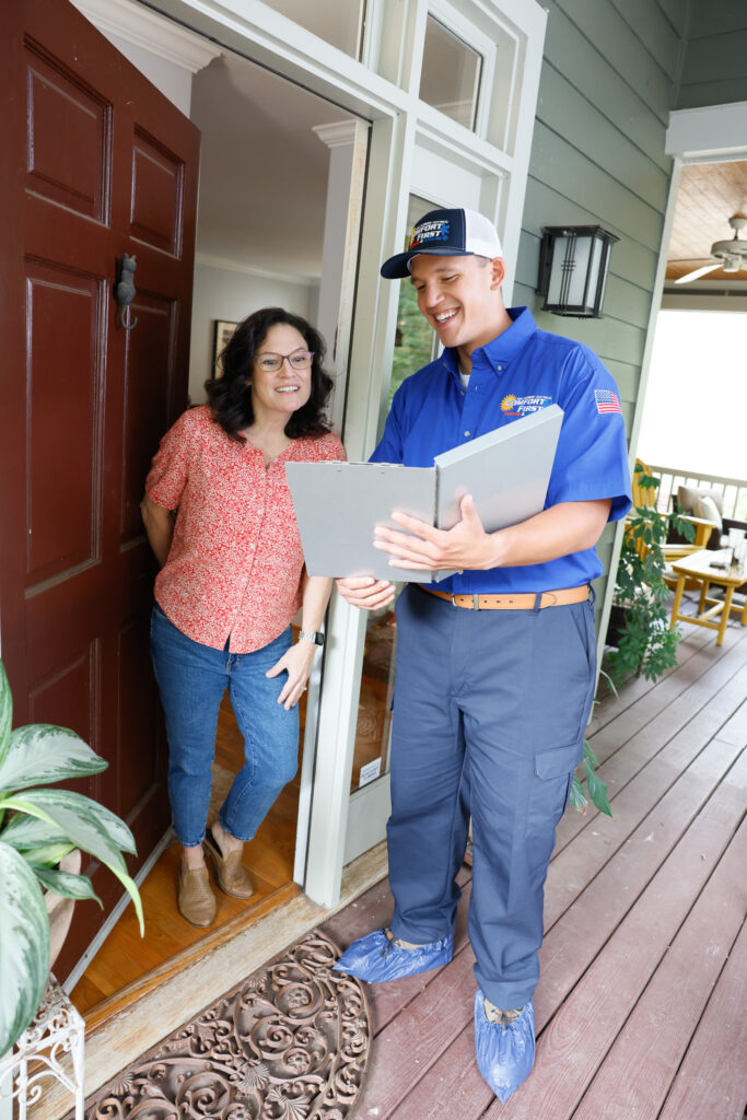 HVAC tech discussing work estimate with woman