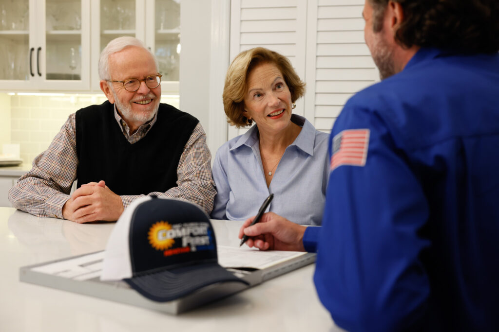 HVAC tech discussing work with home owners