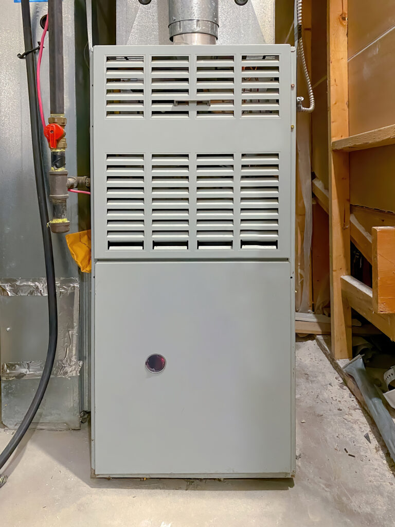 Close-up of a gas furnace installed in a home's basement.